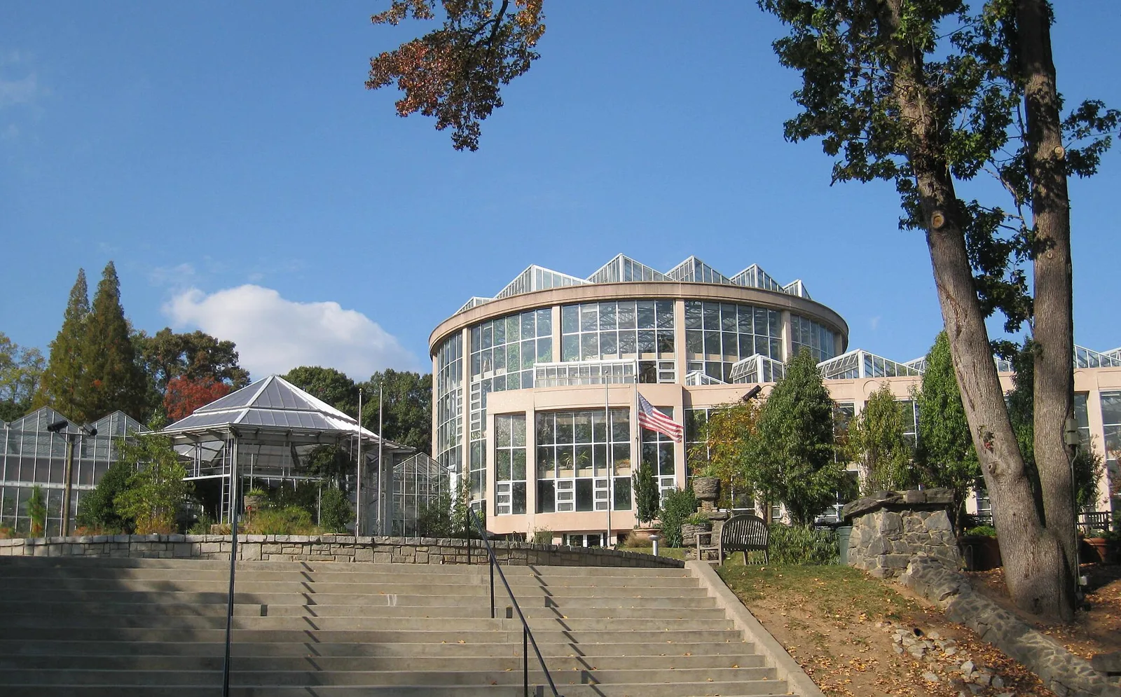 The round glass-topped Fuqua Conservatory at the Atlanta Botanical Garden, seen from the foot of a wide stone staircase